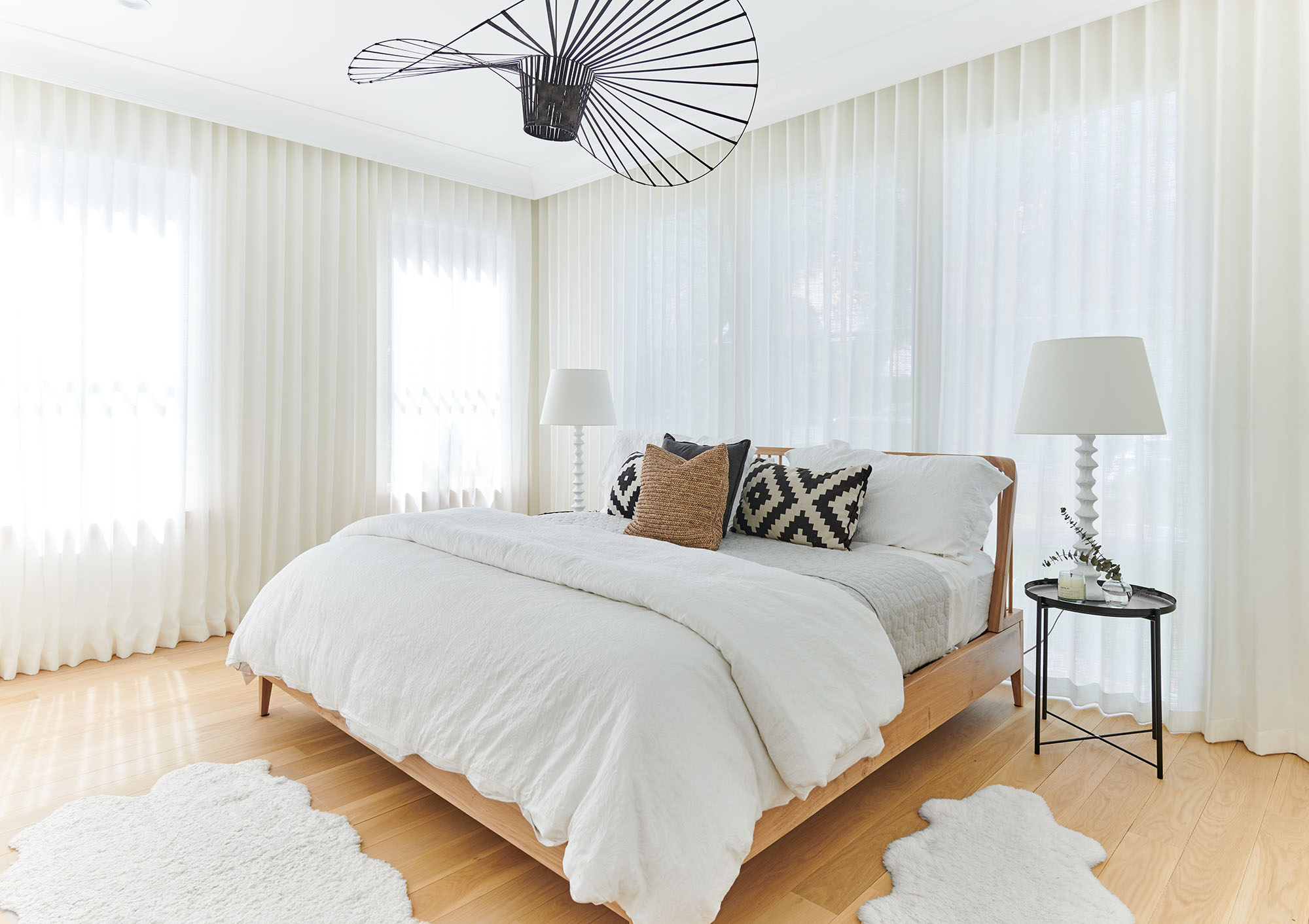 Guest bedroom with sheer curtains and a woven pendant in a Westfield, New Jersey custom home by Ellie Mroz Design.