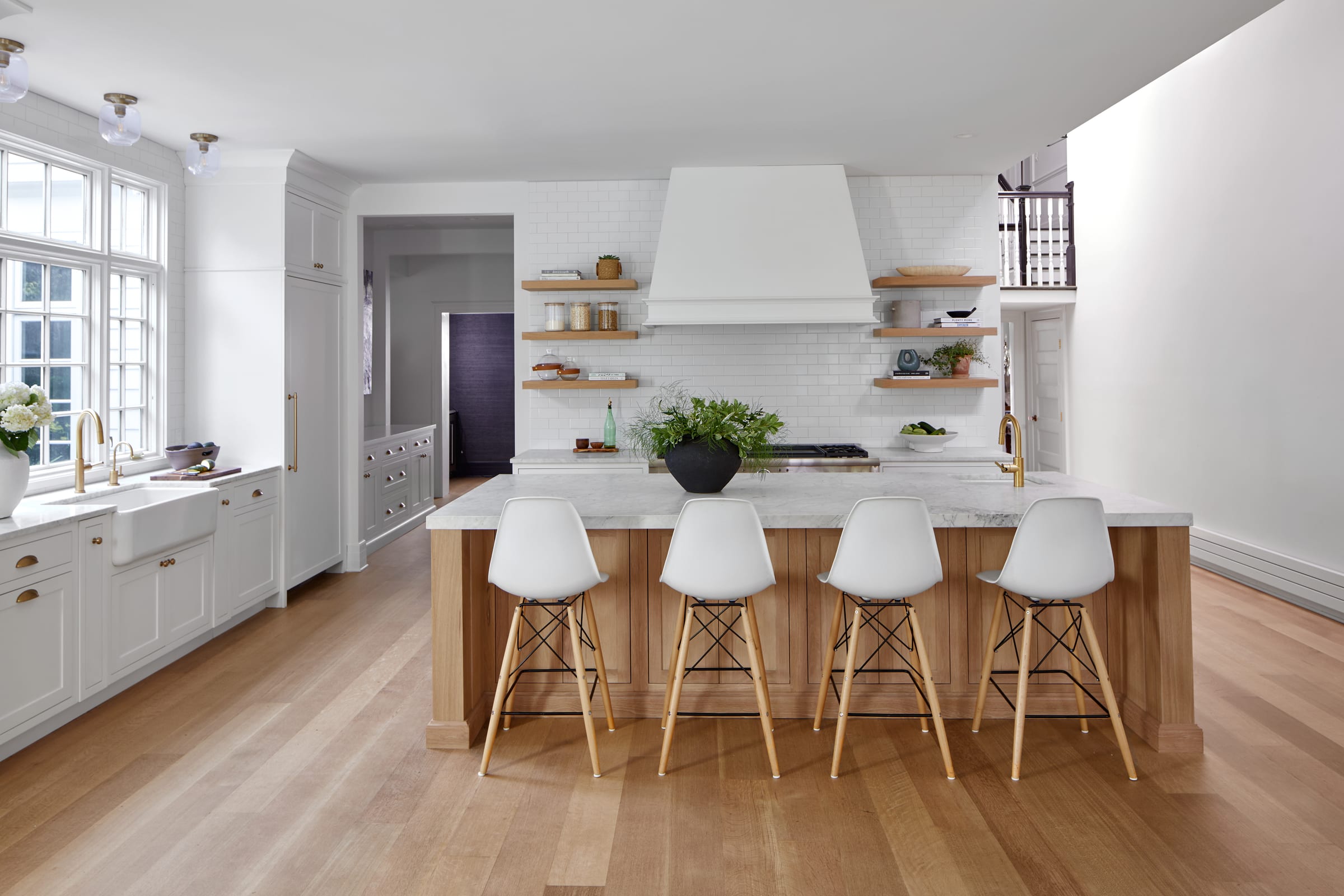 White kitchen with white hood and natural open shelves in historic Westfield NJ.