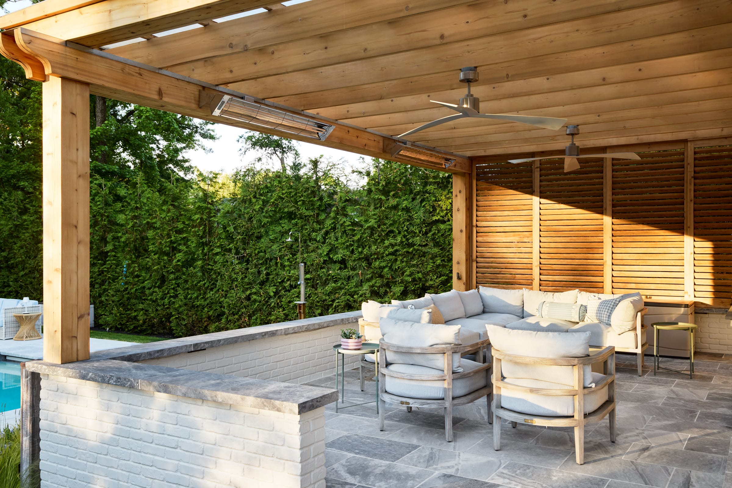 Covered cedar patio with ceiling fans and heaters for extended outdoor living in Westfield, NJ.