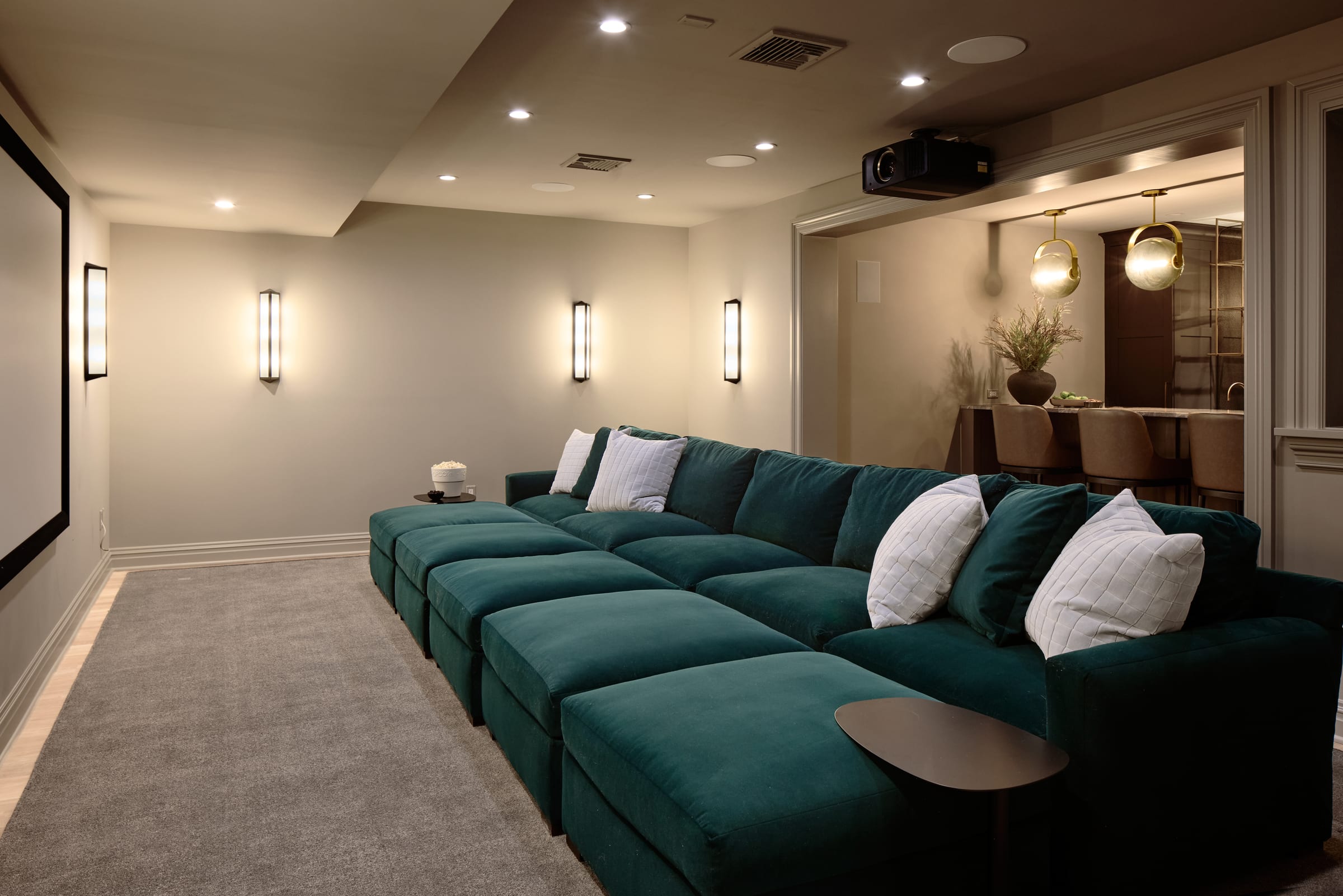 Home theater with tiered seating in a luxury whole-home renovation in Summit, New Jersey by Ellie Mroz Design.